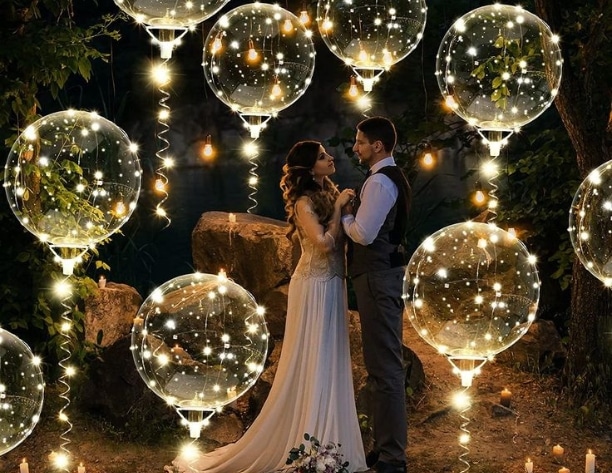 Boho wedding with balloon light decor surrounding the bride and groom