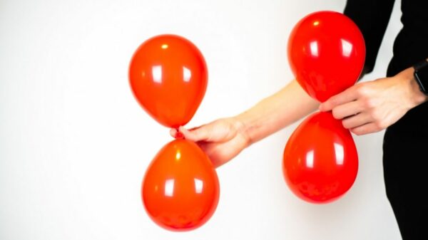 Woman holding red balloons