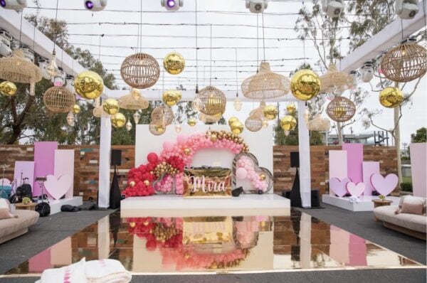 gold disco balls hanging from ceiling at event